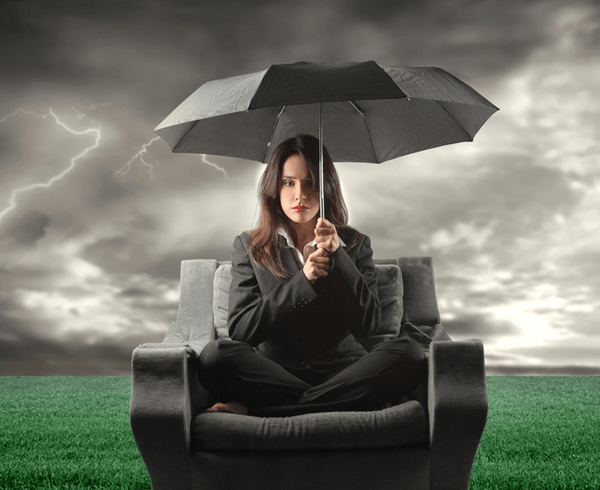 Person sitting on sofa holding an umbrella
