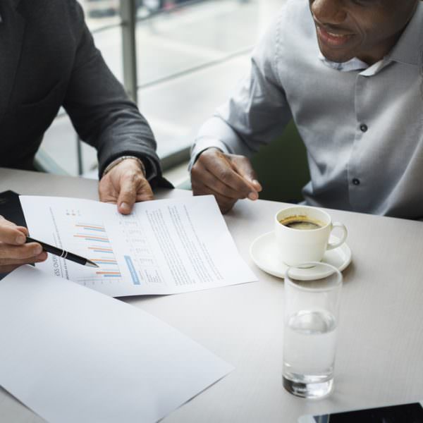 People discussing pensions around a table with an adviser